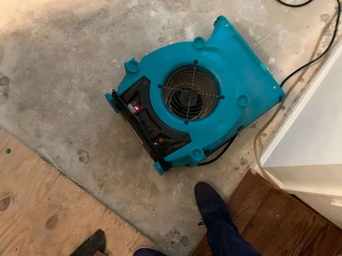 Air mover drying subfloor during Commercial Water Damage Restoration in Ellwood City